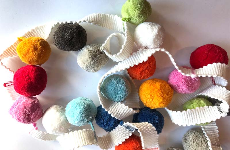 Multi-coloured cotton bobble fringe with duck egg blue, white, red, yellow, pink, brown, pale green, beige, orange, navy and white pompoms on white tape| Multicolour Pompom Bobble Trims 