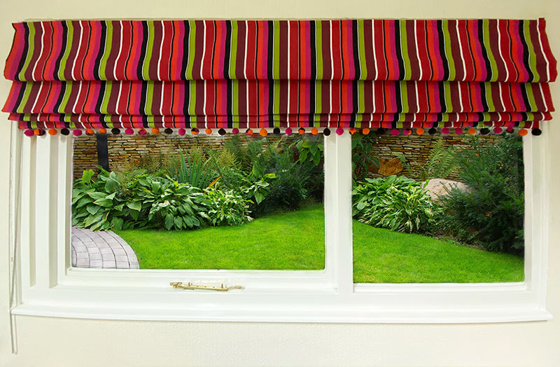 striped roman blind with pompom fringe